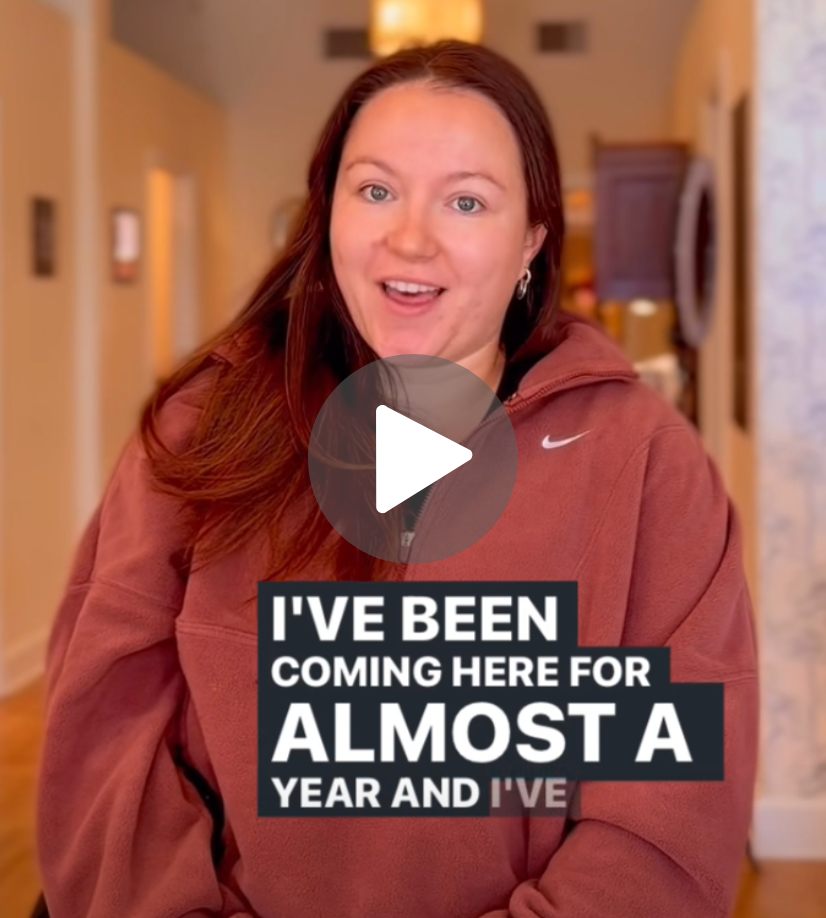 Smiling woman in a maroon hoodie stands in a hallway; bold text overlay reads, "I'VE BEEN COMING HERE FOR ALMOST A YEAR."